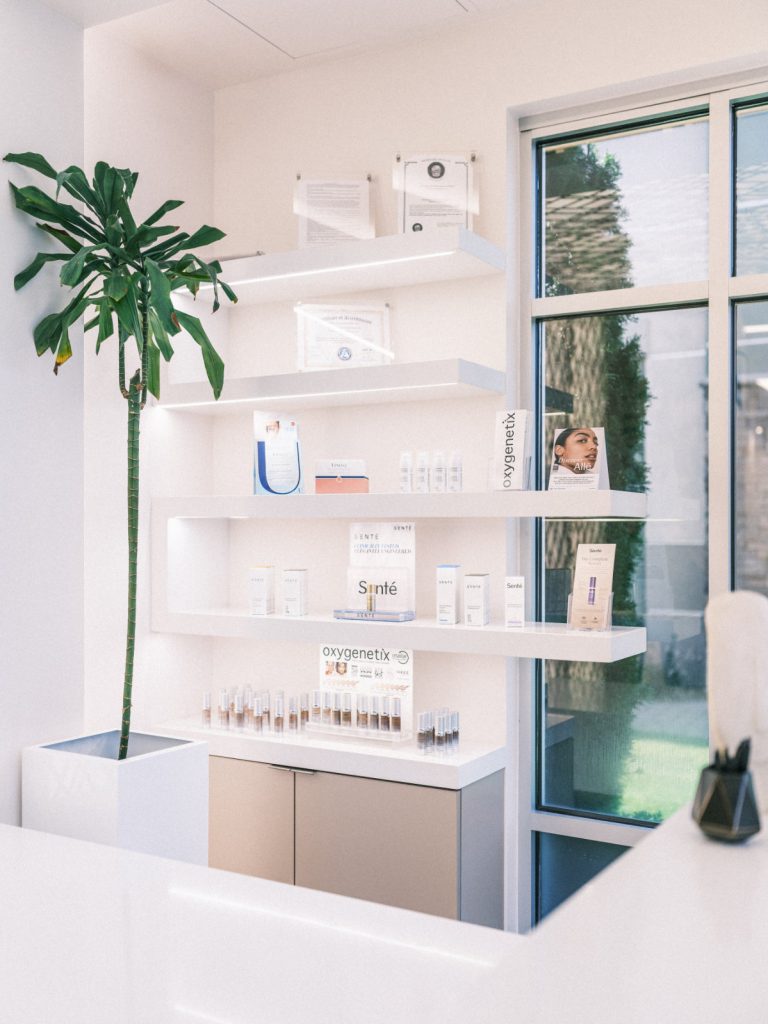 Interior of the clinic with shelves displaying Oxygentix skincare products and certificates